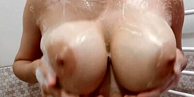 Big natural boobs in foam close up
