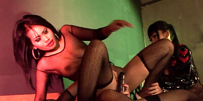Two gothic lesbians dominated by their latex mistress