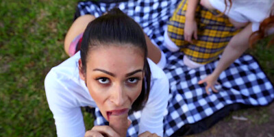 Man with camera gets caressed by two babes in the meadow