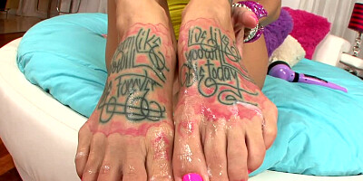 Busty woman with tattoos on her legs is getting cumshot on feet