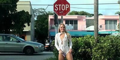 A blonde that poses naked outdoors is playing with herself