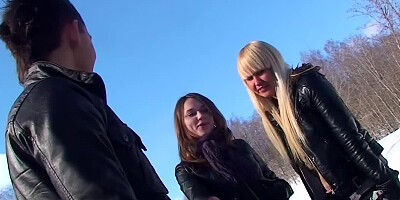Blonde and brunette are fucking a dude in the snow before us