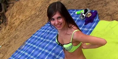 Several girls are getting naked at the beach in a hot scene