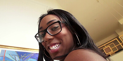 A black chick with big saggy tits is licking a big white pecker