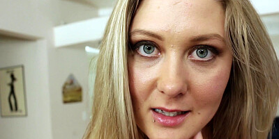 A blonde with blue eyes is getting a facial as she is giving a blow job