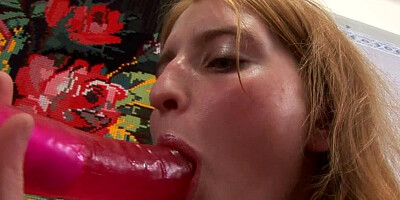 Ginger in solo video uses red dildo masturbating her slit