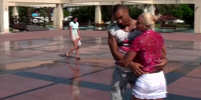 Russian blonde allows black man to play with her tits outdoors