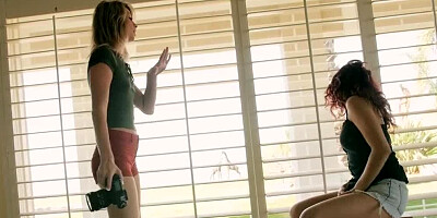 Two girls are undressing and fucking each other during shoot