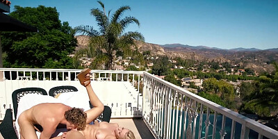 A blonde with a skinny frame is getting rammed on the balcony