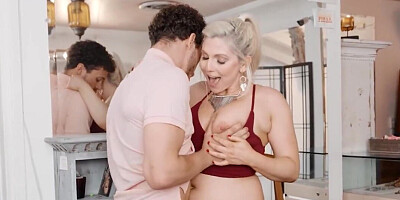 A redhead and a blonde are having sex with a dominant man