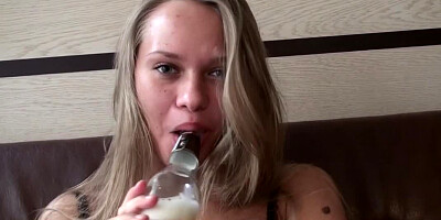 A blonde is drinking some booze before having passionate sex
