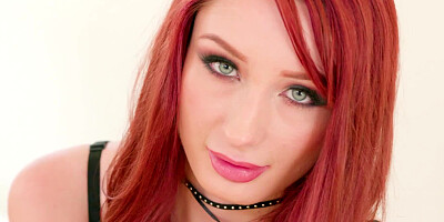 A redhead with hot lingerie on is licking a large hard cock