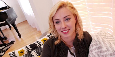 A blonde with pretty blue eyes is on her knees, doing a blow job