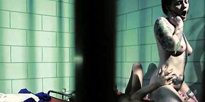 Horny tattooed lesbian fucks her girlfriend in a prison cell