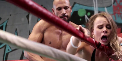 Muscular stud manhandles busty blonde babe in a boxing ring