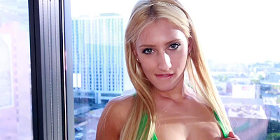 A sweet blonde with a sexy smile is undressing and sucking dick