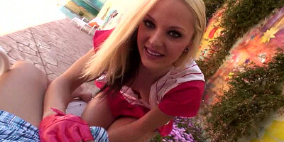 A smiling little lady is removing her shirt and panties as well