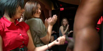 Wild ladies are cheering as a guy gets naked. Then they tug his willy