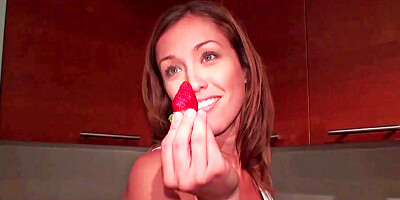 Brunette licks a strawberry before she licks a hard shaft