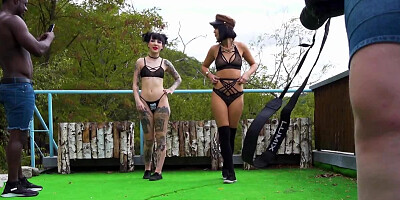 Two horny chicks are posing for the camera outdoors