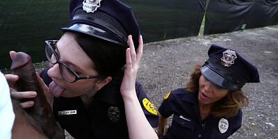 Two lady cops are having a threesome with a large black dude