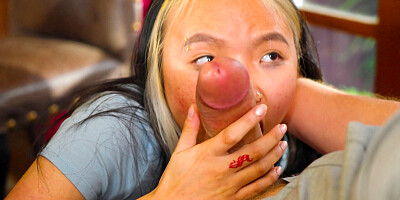 Asian girl wraps her lips around a massive cock and sucks it