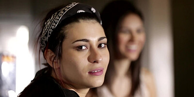 Two girls are licking and caressing one another in a hot manner