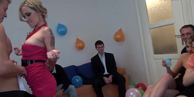 Sexy women are partying with men and they are doing a striptease