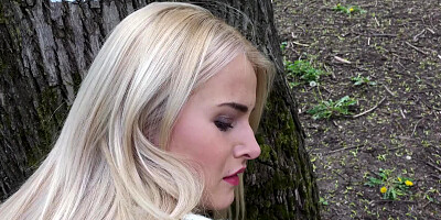 A lovely blonde is in the forest and she is giving a blow job