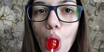 Student with glasses sweetsucks lollipop and dick