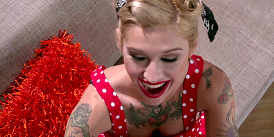 A blonde with hot tattoos is giving a blow job to her partner