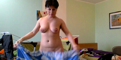 Naked MILF taking care of her laundry