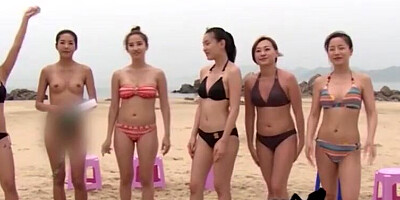 Lovely Asian chicks are getting naked at the public beach