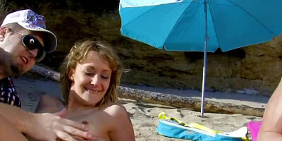 Slutty MILF is fucked by two strangers on the beach