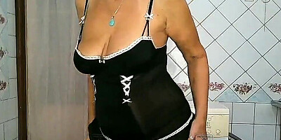 Slutty mature lady is stripping and teasing on the camera
