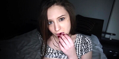 A redhead is taking on a cock in a dimly lit room before us