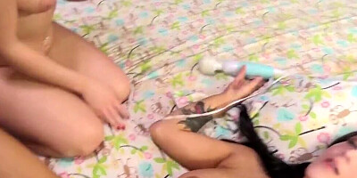 Two college hussies are using a magic wand on their pussies during sex