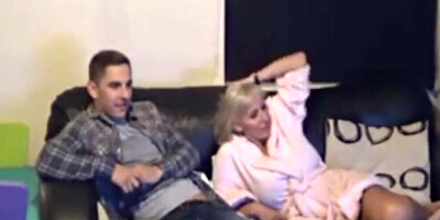 Blonde girl and her boyfriend are cuddling on the couch