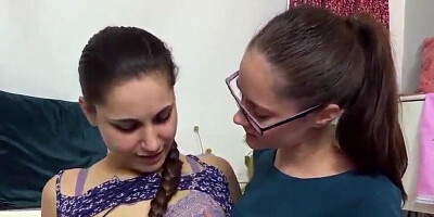 Nerdy brunette lesbians are kissing, fingering and licking one another