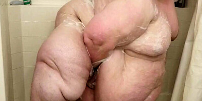 Huge woman is showing her naked body while having a shower