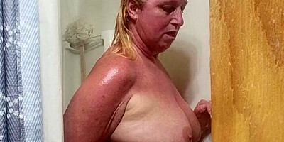 Blonde taking hot shower