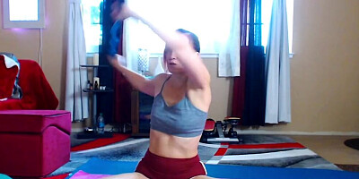 Cute redheaded doll is stretching in front of the camera