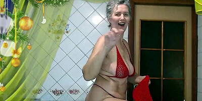 Another video recording of an online broadcast where a hot housewife in the kitchen puts on red lingerie to cheer up