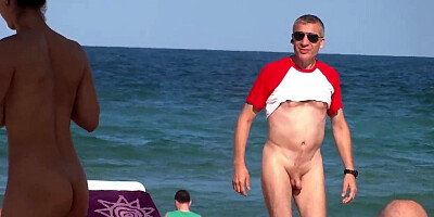 Male is interested in naked body of a housewife on beach