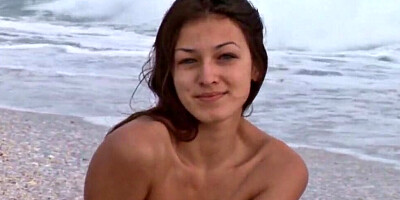 Busty brunette sweetheart Femjoy Sofie is posing totally naked at a beach