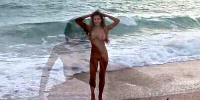 Busty brunette sweetheart Femjoy Sofie is posing totally naked at a beach