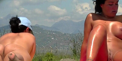 Voyeur is filming busty cougar while she sunbathes on a sunny day