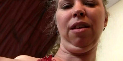 Chubby mature woman is stimulating her cunt with a sex toy