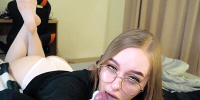 Nerdy girl is filmed POV-style while licking and sucking hard cock