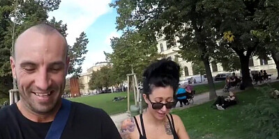 Tattooed and busty MILF pornstar talks kinky during a strolling interview outdoors